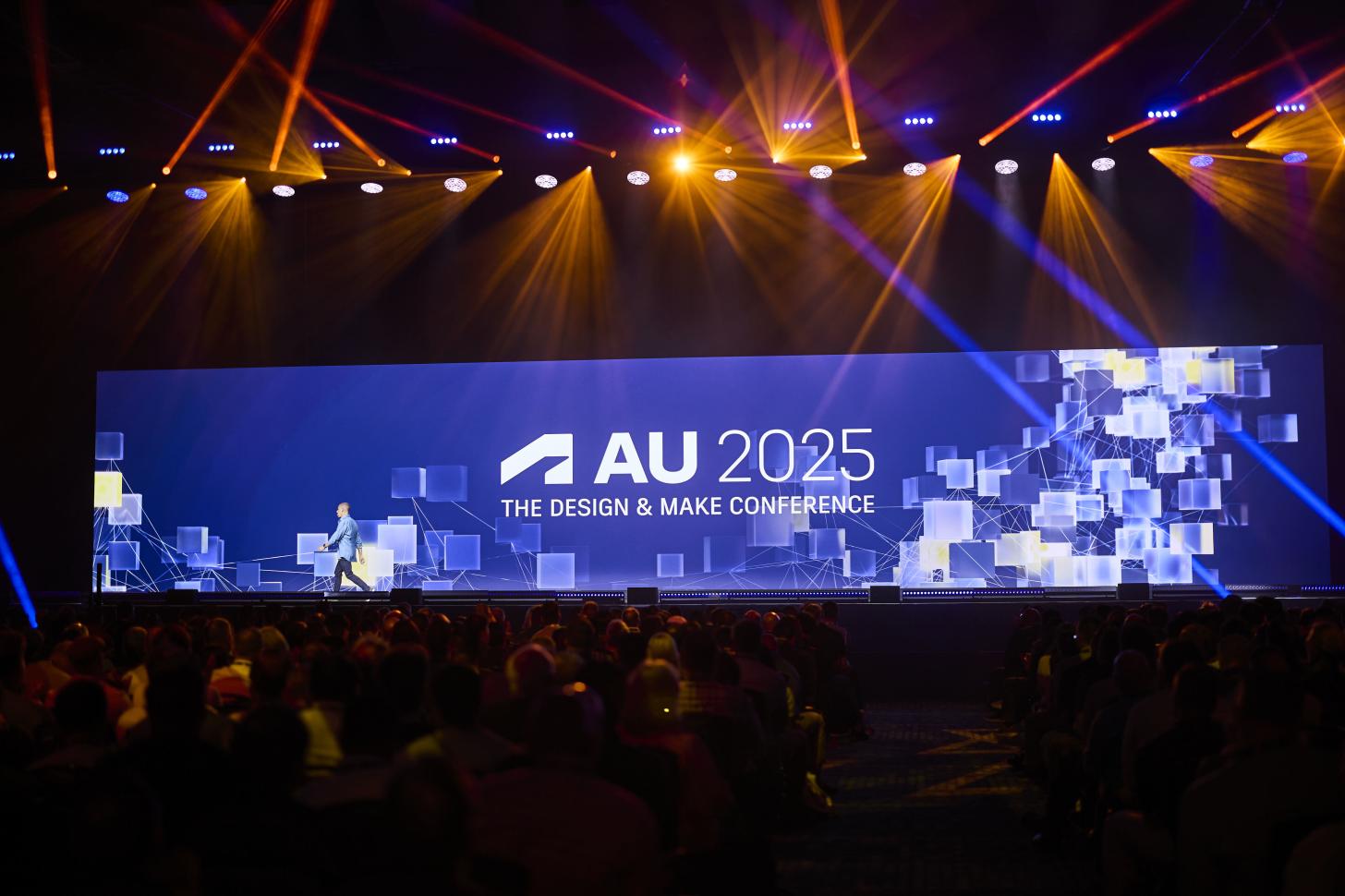 Photograph of the Autodesk University 2025 Main Stage with the words AU 2025
