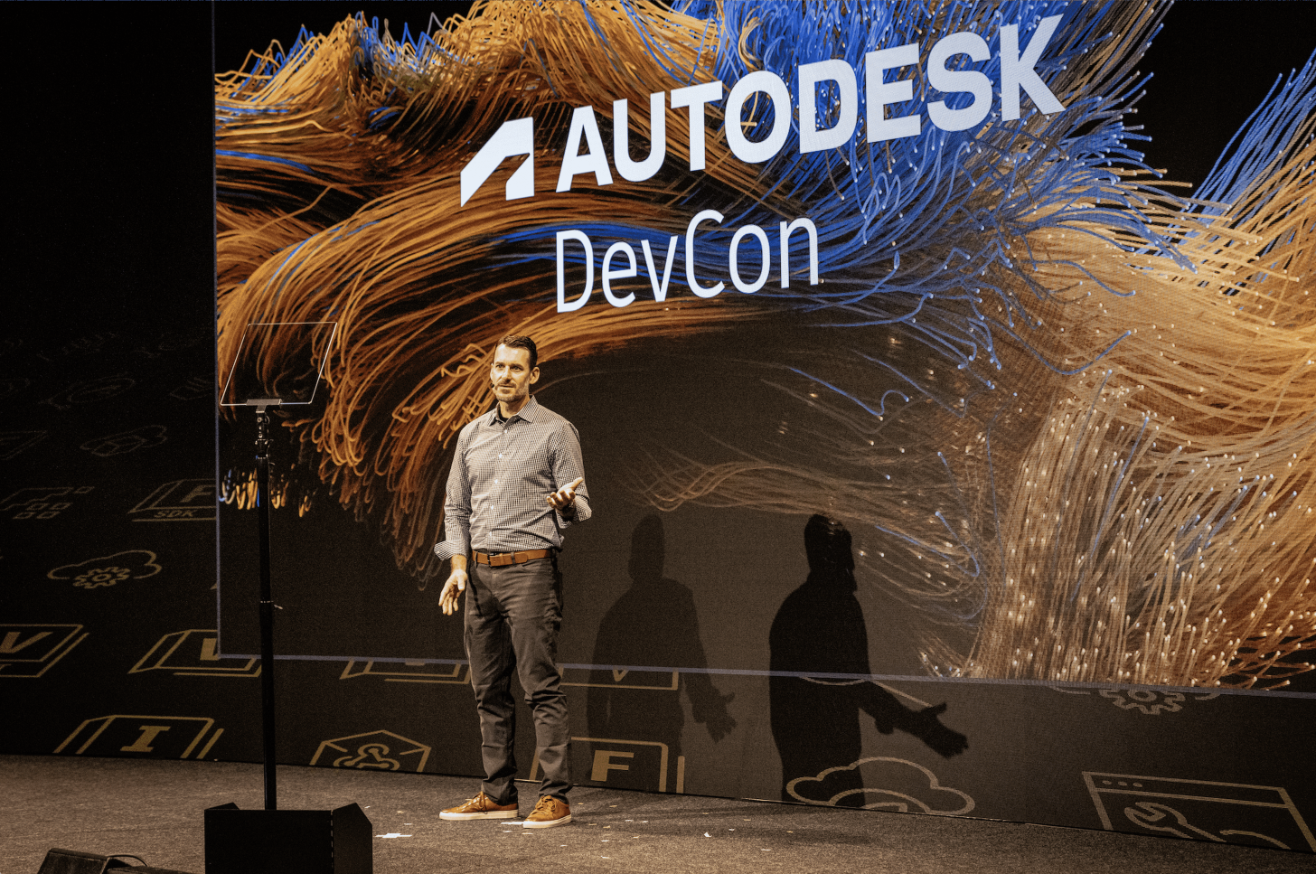 A man stands on the stage at Autodesk DevCon 2025.