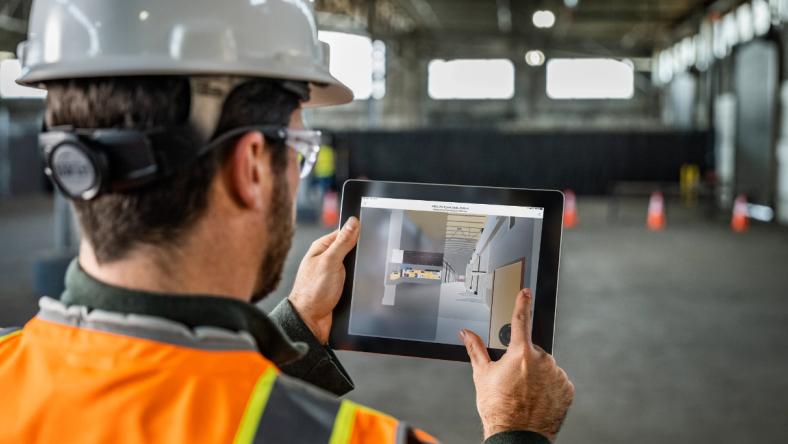 Construction worker looking at tablet